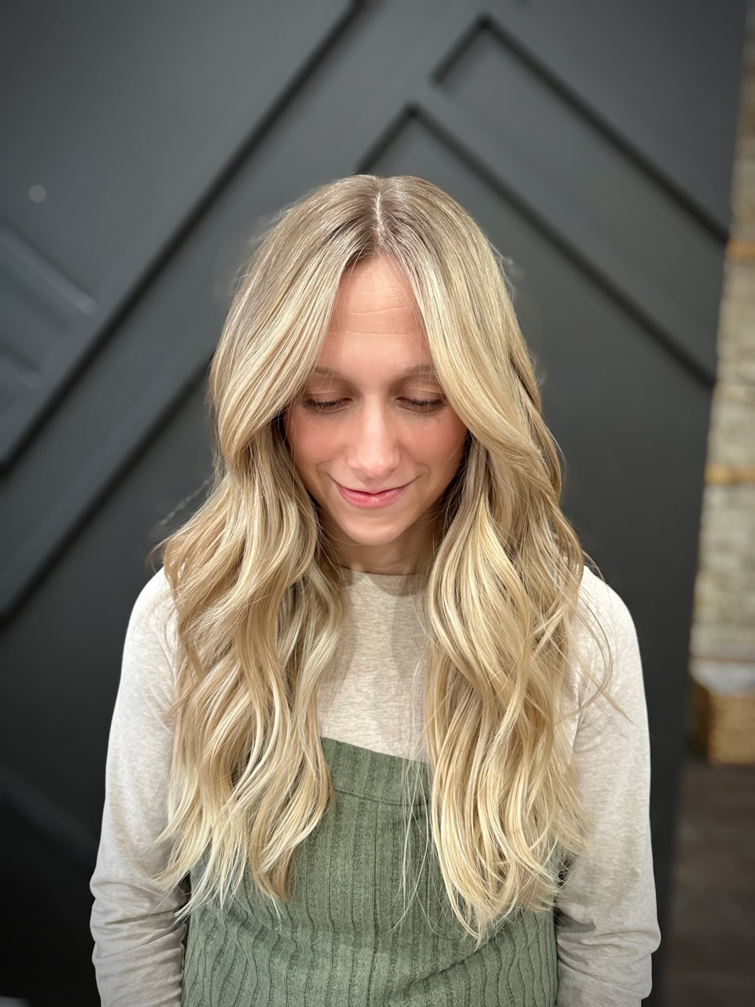 Bright buttery blonde worn long and wavy, brightest around the face