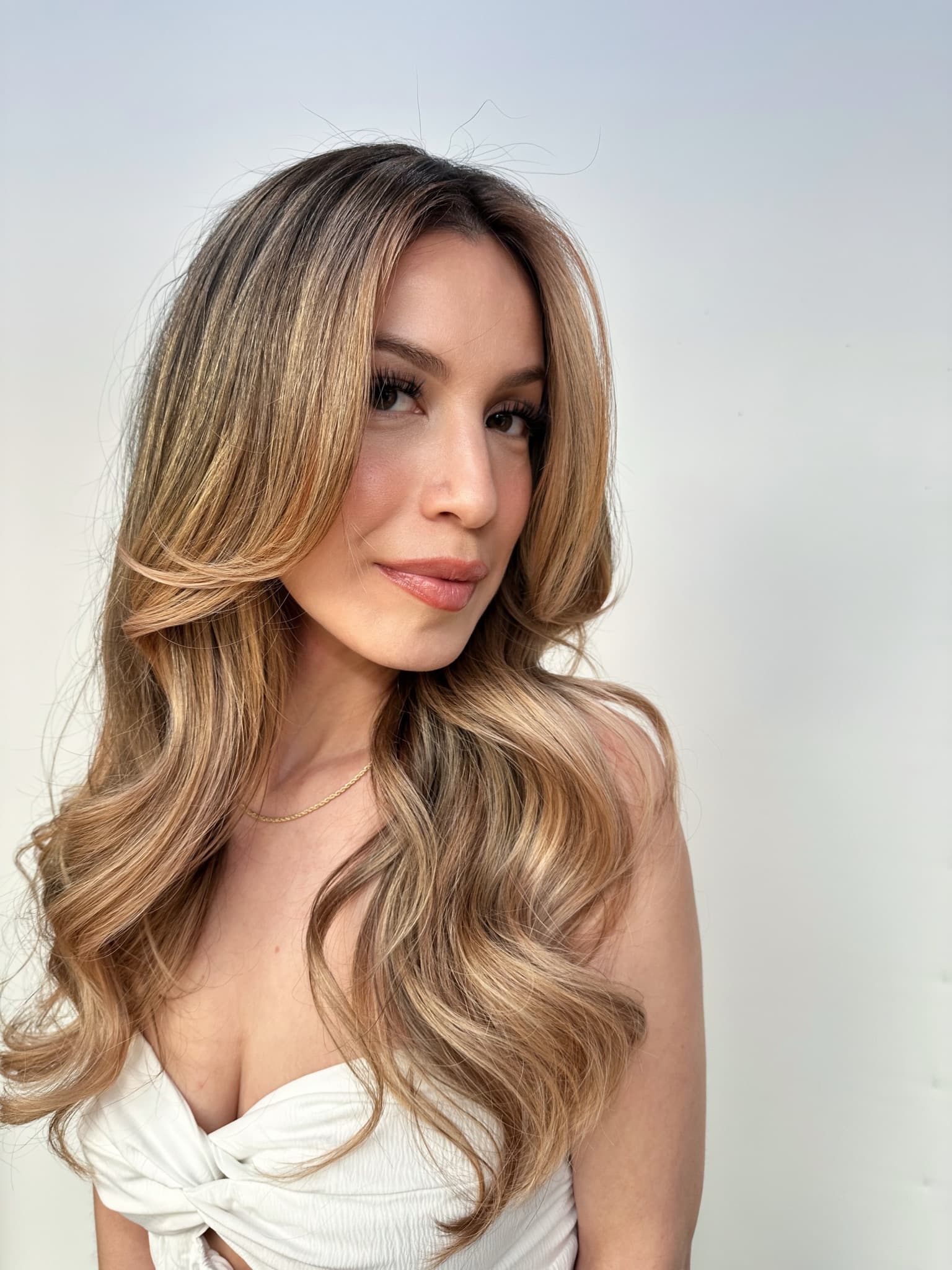 Bronde balayage on long waves, cool at the root and warming through the ends
