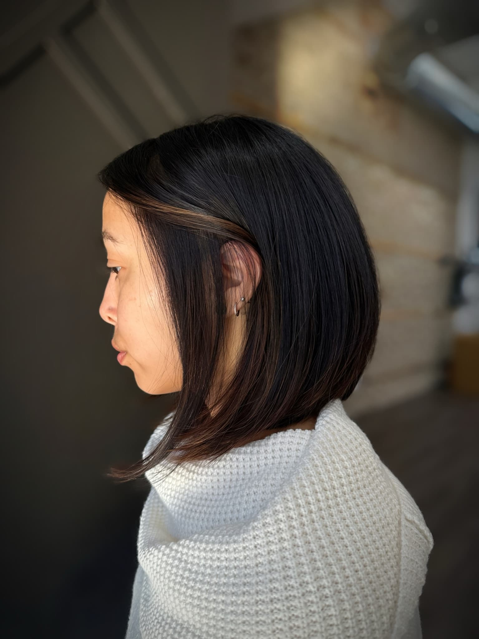Sleek dark lob cut to a clean blunt line just below the jaw