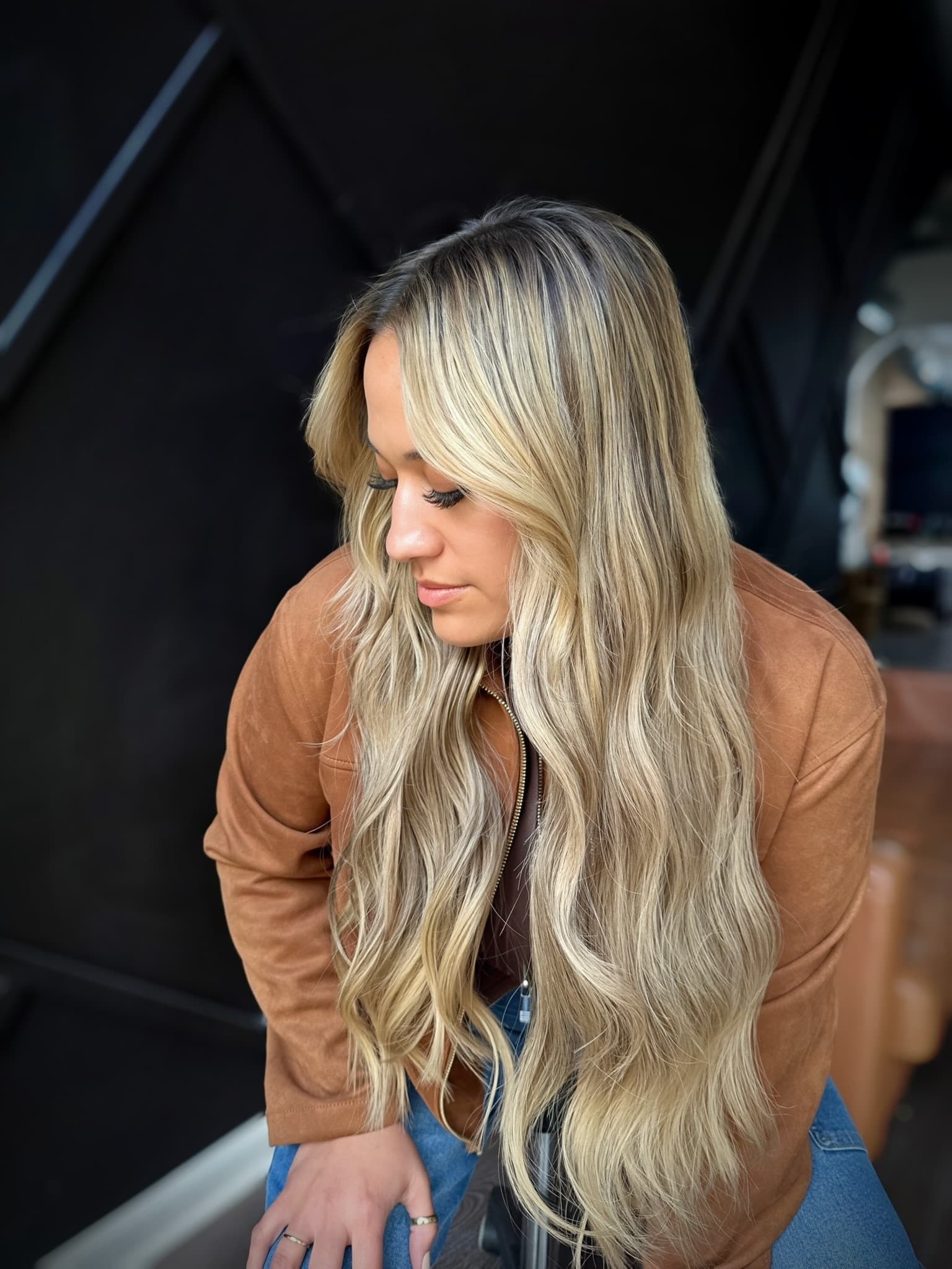 Long blonde waves with dimensional balayage, extensions blended through the ends