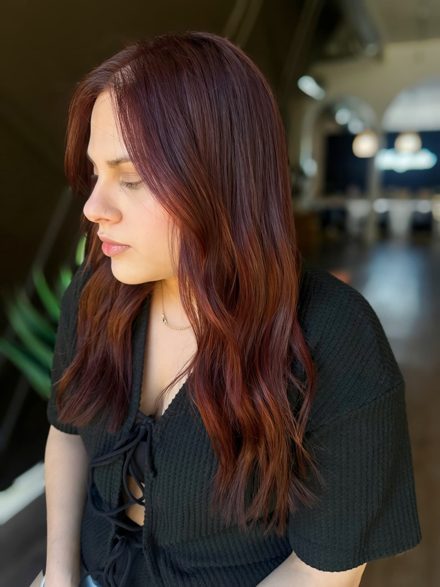 Auburn waves in profile, extensions color-matched to the natural hair